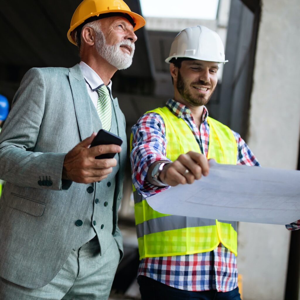 Construction engineer with foreman worker checking construction site